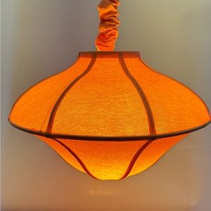 Hanging lamp in pink/peach canvas.